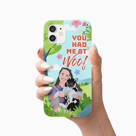 A dog lover holding a smartphone with the Ecomartists You had Me At Woof Phone Case Personalized featuring a graphic of a person and a dog and the phrase "you had me at woof.
