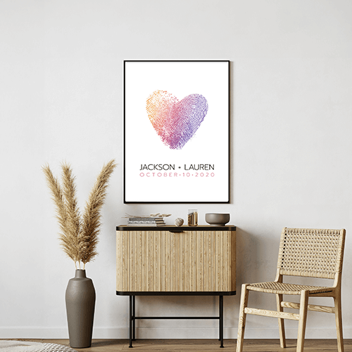 A watercolor heart print on a wall in a living room.