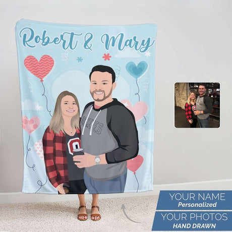 A Personalized Couples Name Blanket by Ecomartists featuring custom hand-drawn illustrations of a couple, with the names "Robert & Mary" at the top, floating hearts and stars around, and a small inset photo of them.